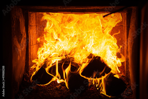 Christmas fireplace. Fire texture. Flame background. Burning wood. Cozy fire.