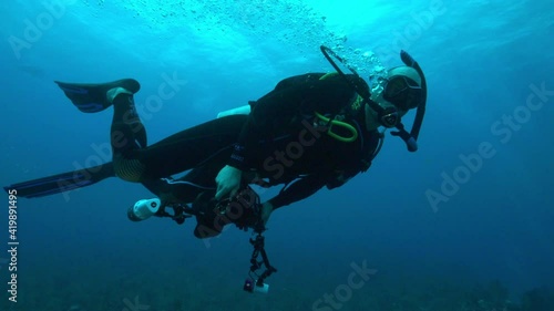 Wallpaper Mural Slow Motion: Scuba Diver Swimming While Gesturing In Blue Sea Torontodigital.ca