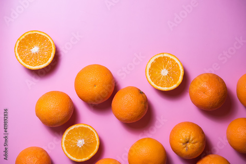 various oranges on an exotic background. oranges on a pink background