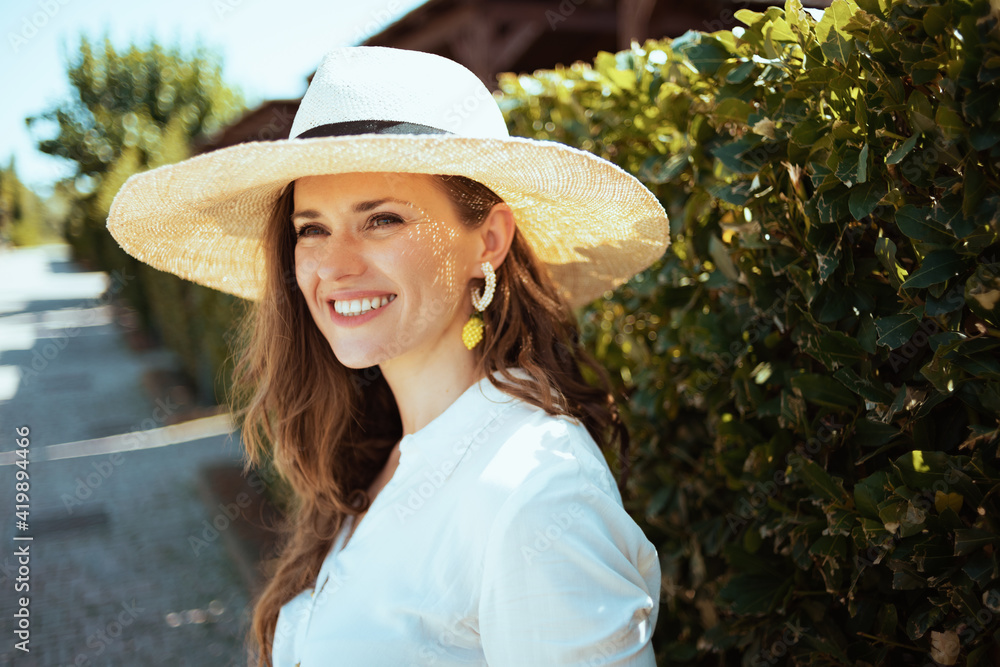 happy elegant woman in white shirt with hat