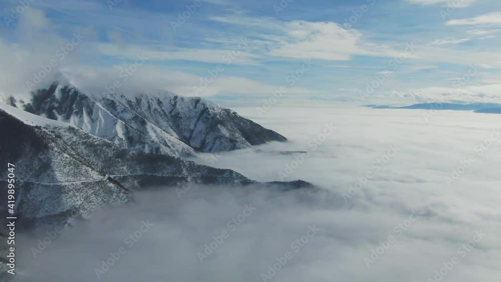Aerial view of a mountain valley covered with snow during the winter. Aerial view of a mountain valley covered with snow during the winter.