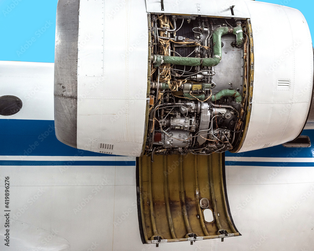Jet aircraft turbine with an open lid removed for maintenance. Jet aircraft turbine with an open lid removed for maintenance.