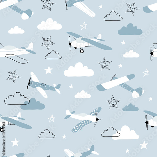 Vector hand-drawn seamless repeating children simple pattern with aircraft, stars and clouds in Scandinavian style on a blue background.Kids seamless pattern with planes. Funny airplanes.