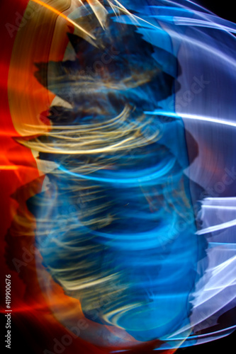 Refraction of colored rays of light through a specially trembling transparent ball of water. Blurred focus image to create background