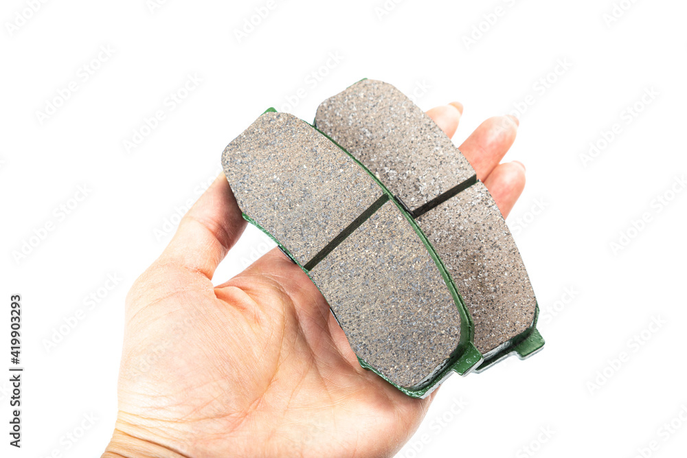 Obraz premium brake pad in hand, car spare parts isolated on white