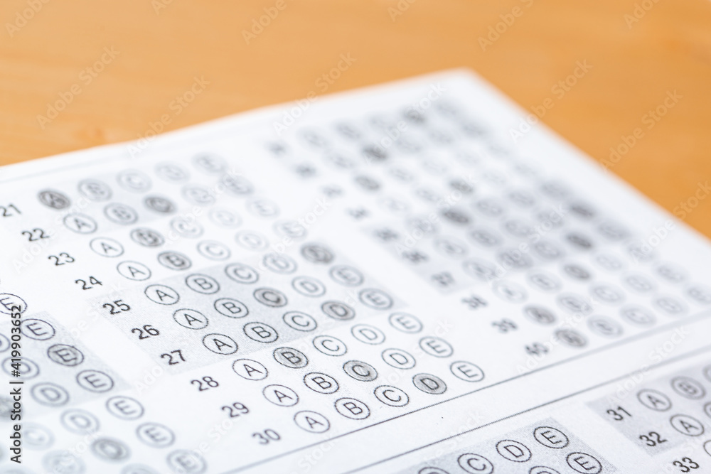 testing in exercise and exam paper. computer sheet with pencil in school test room, education concept. filling in answers in pencil testing in exercise and exam paper. computer sheet with pencil in school test room, education concept. filling in answers in pencil