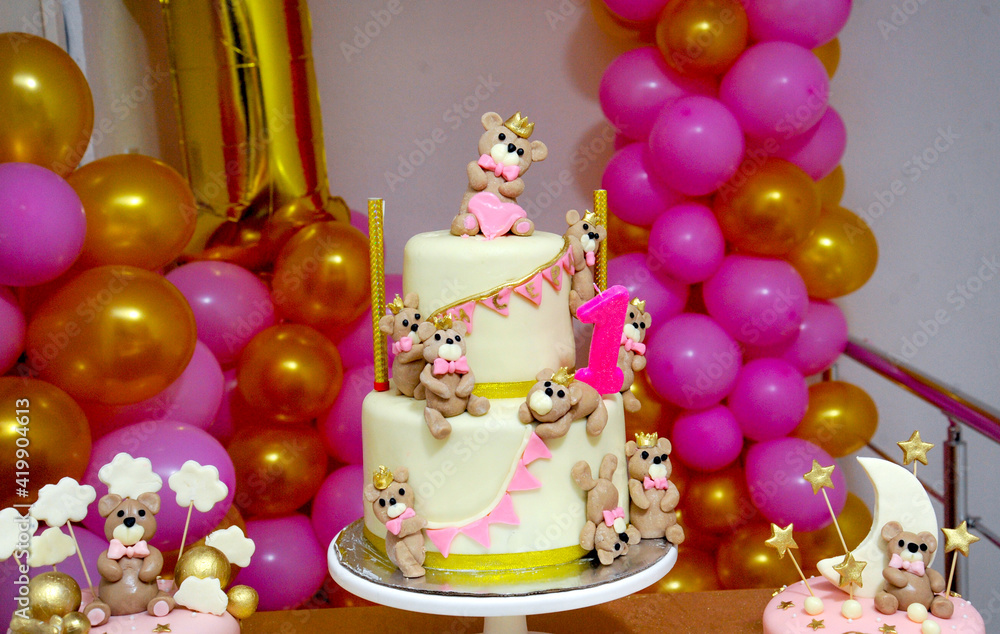 baby girl birthday cake with cute teddy bear figurines