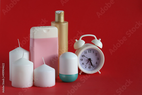 set for spa treatments and stearin candles on a red background photo