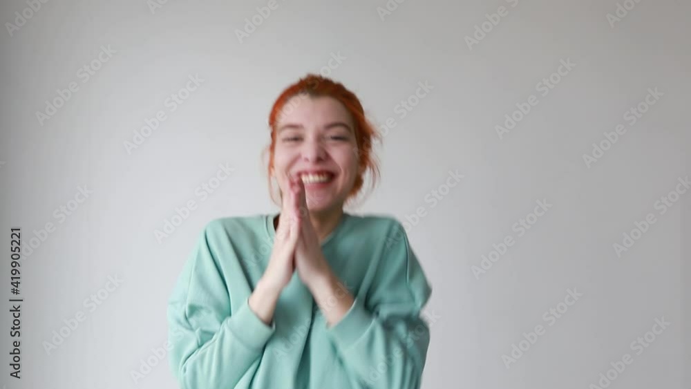 Young girl looking happy showing yes gesture and rejoicing on camera over white background. Winner expression Young girl looking happy showing yes gesture and rejoicing on camera over white background. Winner expression