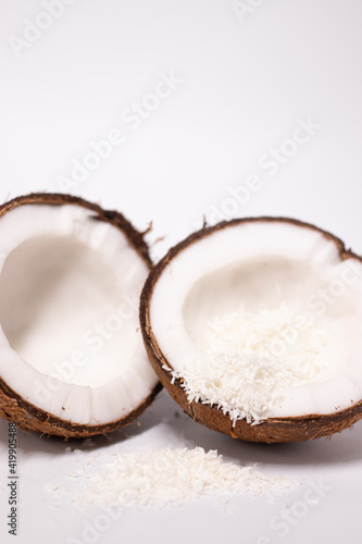 opened coconut with coconut flakes isolated on white background. tropical, nut