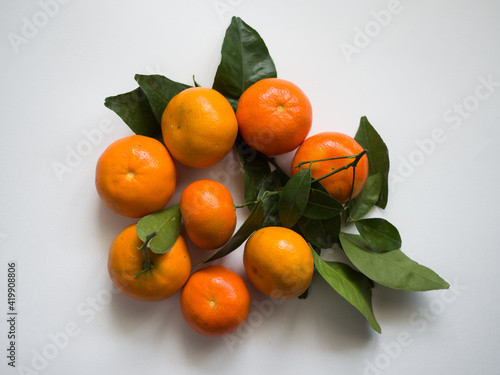 Tangerines with leaves on a white background. Chinese sweet tangerines
