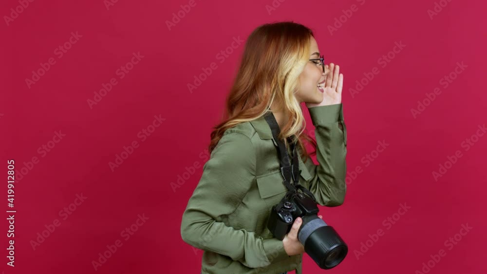 Young blonde girl photographer shouting to the lateral and announcing something over isolated background Young blonde girl photographer shouting to the lateral and announcing something over isolated background