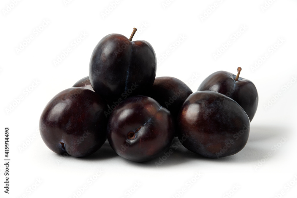 Black cherry plums on the white table
