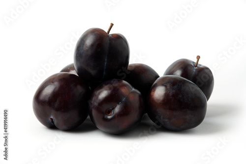 Black cherry plums on the white table