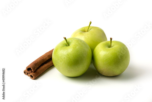 Green apples and cinnamons isolated on white background