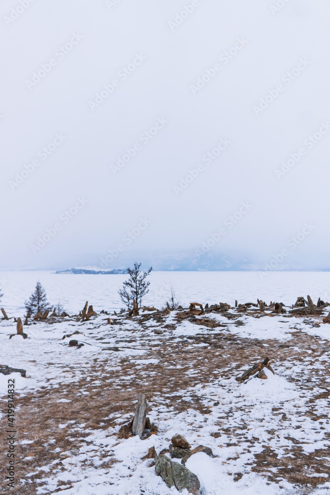 Fototapeta premium Pyramids of stones in winter on Lake Baikal.