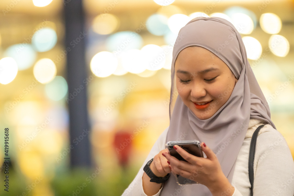 Beautiful Malay girl outdoor using smartphone Beautiful Malay girl outdoor using smartphone