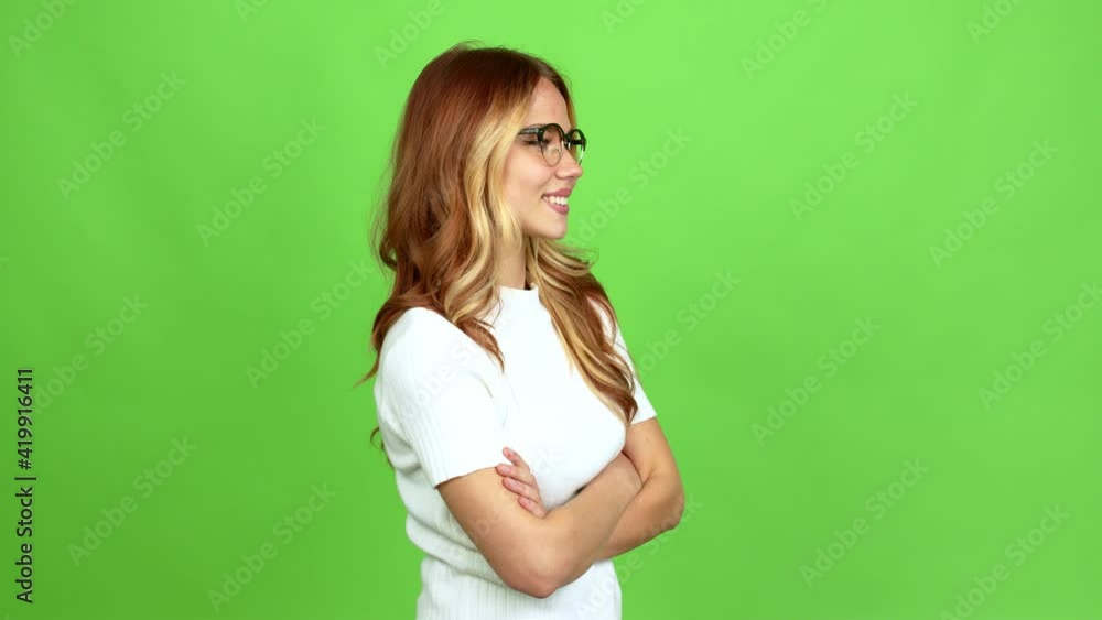 Young blonde girl with glasses looking side over isolated background on green screen chroma key Young blonde girl with glasses looking side over isolated background on green screen chroma key