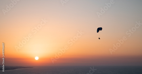 Parachuting - Paragliding in sunset