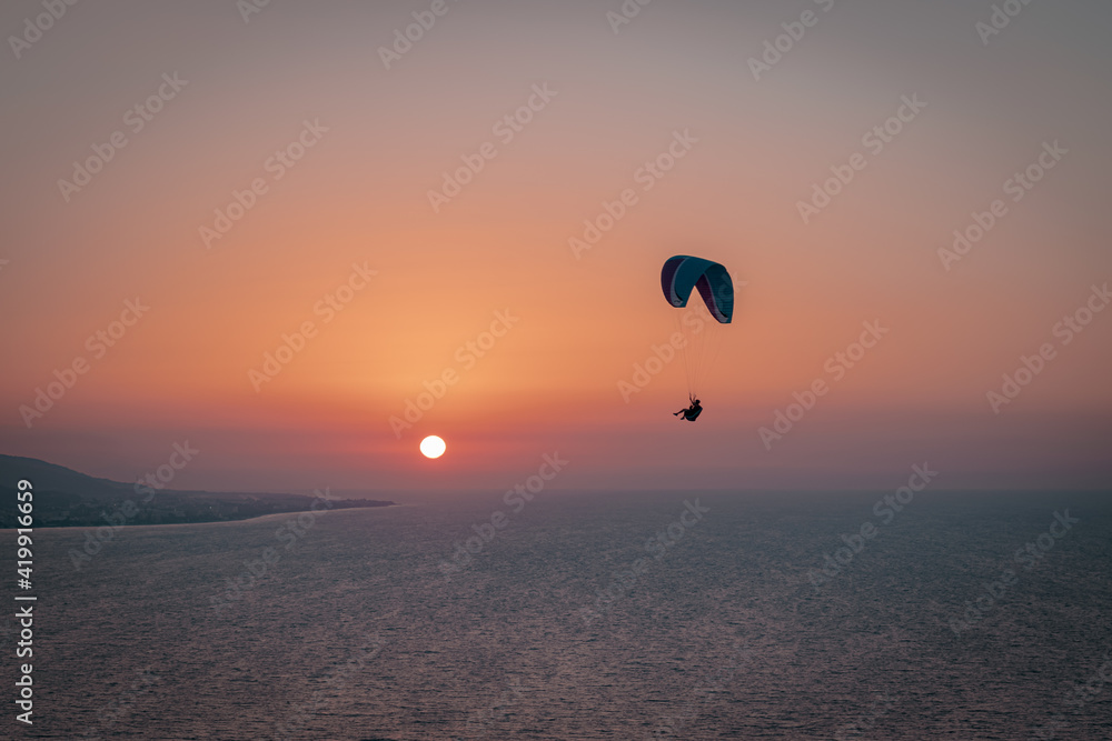 Parachuting - Paragliding in sunset