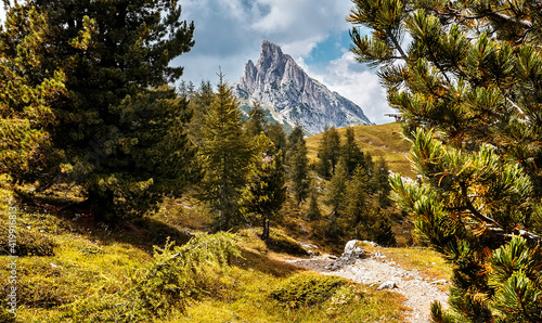 Breathtaking nature scenery of mountains. Awesome alpine highlands in sunny day with mountain range, perfect sky, trees and grassy hills. Stunnng summer scenery of Dolomites Apls. Natural background. photo