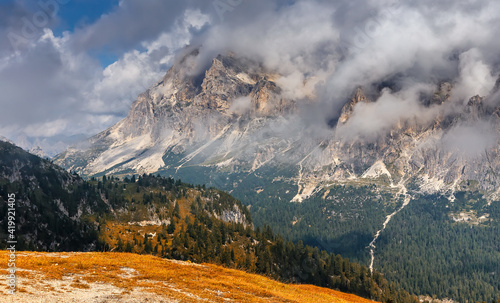 Amazing nature lanscape. Unsurpassed scenery in Dolomite. Cloudy mountain Tofana di rozes of the Dolomites near Cortina D'ampezzo in Italy. Concept of ideal resting place. Popular travel destination.