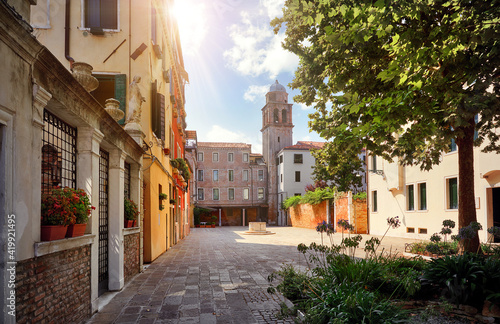 Venice Italy. Picturesque yard old town with tower and vintage houses. Sunny day.