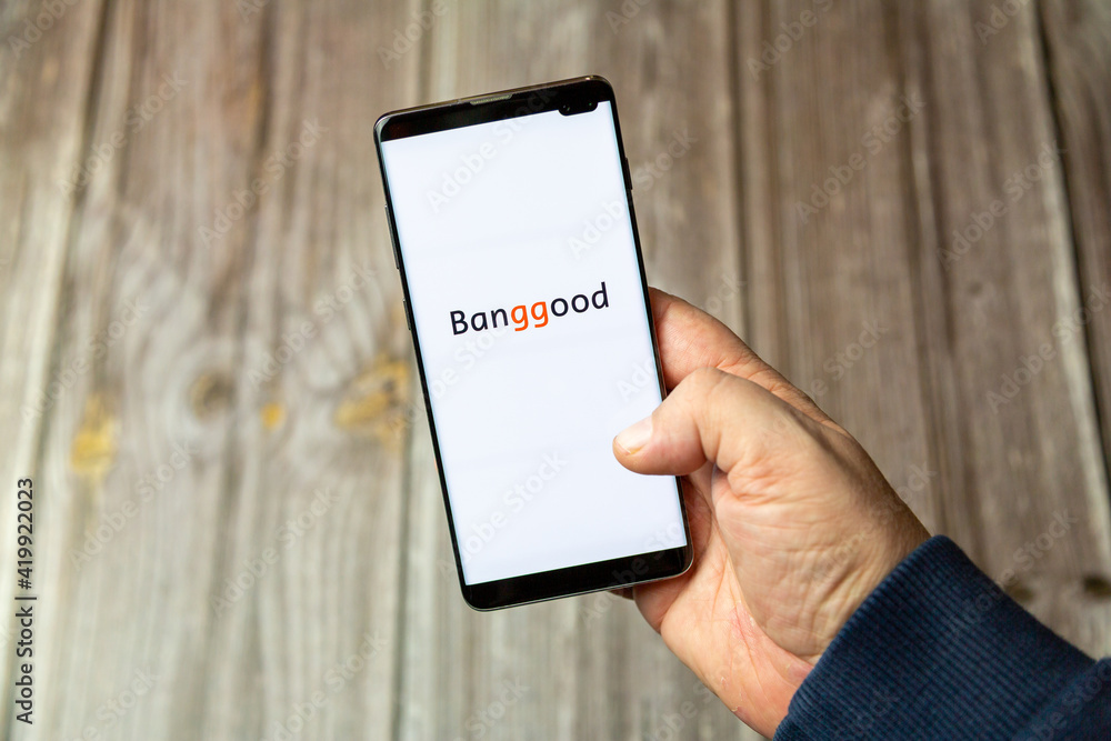 03-10-2021 Portsmouth, Hampshire, UK A Mobile phone or cell phone being  held in a hand with the banggood app open on screen Stock Photo | Adobe  Stock