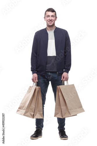 smiling young man with shopping bags . isolated on a white