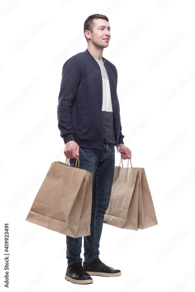 smiling young man with shopping bags . isolated on a white smiling young man with shopping bags . isolated on a white