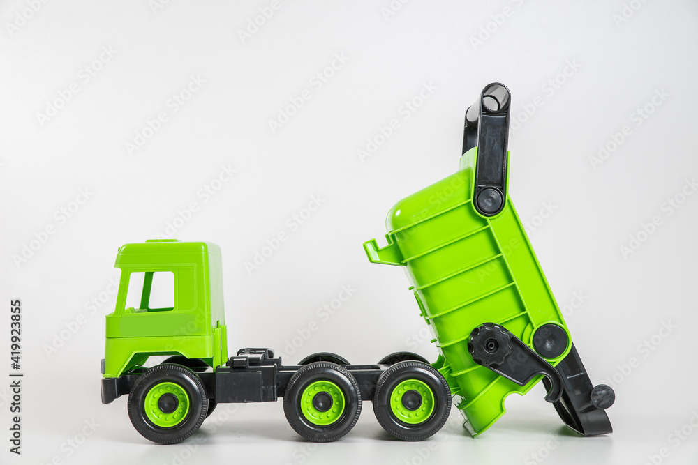 Plastic car. Toy model isolated on a white background. Green truck. Plastic car. Toy model isolated on a white background. Green truck.