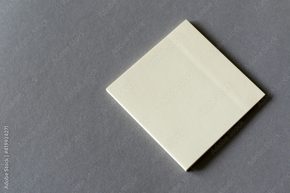 empty yellow memory sticky note on grey background empty yellow memory sticky note on grey background