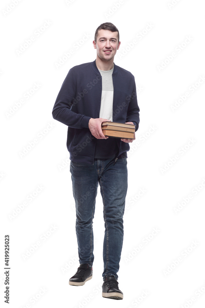young man with a stack of books striding forward. young man with a stack of books striding forward.