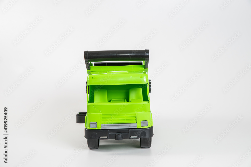 Plastic car. Toy model isolated on a white background. Green truck. Plastic car. Toy model isolated on a white background. Green truck.