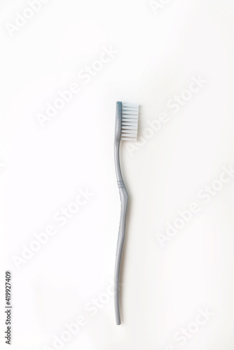 one gray toothbrush on a white isolated background. the concept of oral care and dental care