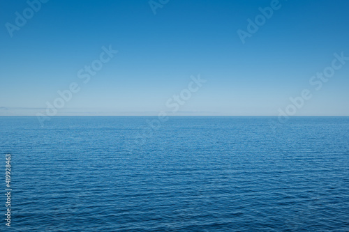 The Baltic Sea on a sunny day with horizon and blue sky.