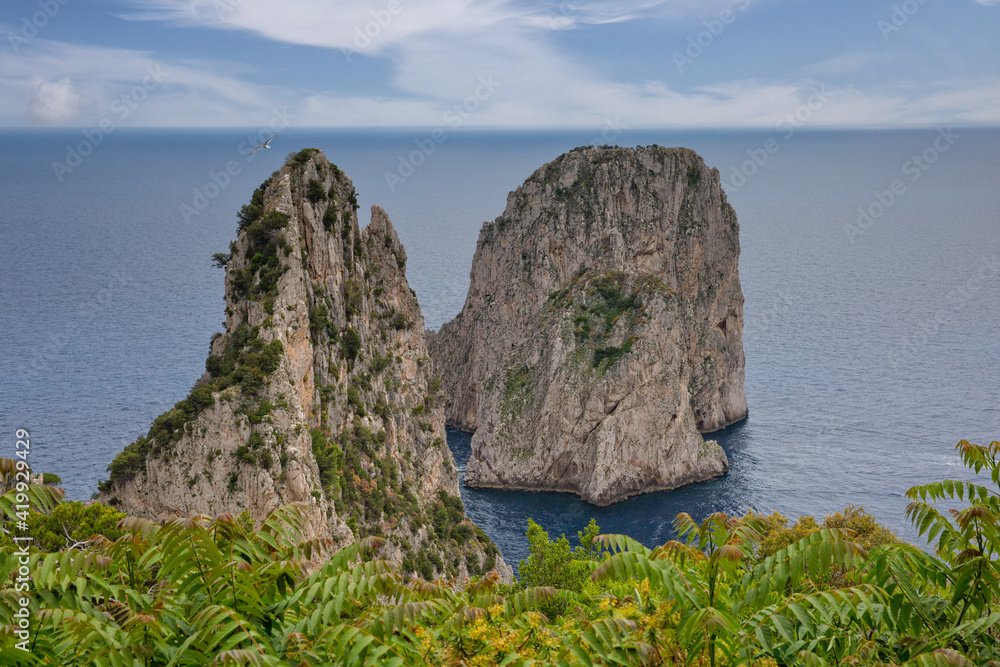 The Faraglioni Rocks located on the coast of Capri have always been one of the main attractions of the small island.View of the famous Faraglioni Rocks in the blue Tyrrhenian sea, Capri island, Italy