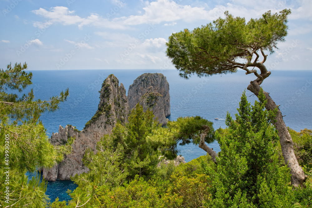 The Faraglioni Rocks located on the coast of Capri have always been one of the main attractions of the small island. View of the famous Faraglioni Rocks in the blue Tyrrhenian sea, Capri Island, Italy