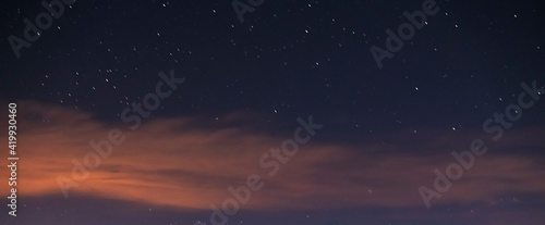 Starry sky with clouds. Night sky background. 
