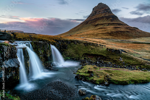 Fototapeta Naklejka Na Ścianę i Meble -  The famous Kirkjufell mountain in western Iceland also commonly referred to by a famous wizards hat. Shot during sunset, long exposure and vibrant colors