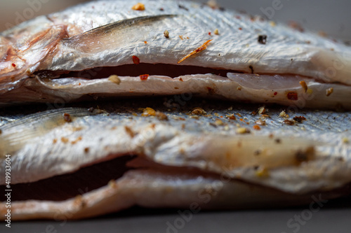 marinated fish belly with spices for cooking close-up