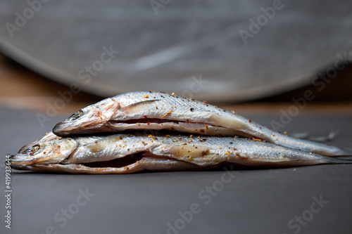 Small river fish marinated on gray background