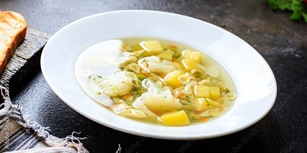 soup vegetable first course meal broth, potatoe, cauliflower, pasta no meat vegetarian or vegan portion on the table snack top view copy space food background soup vegetable first course meal broth, potatoe, cauliflower, pasta no meat vegetarian or vegan portion on the table snack top view copy space food background