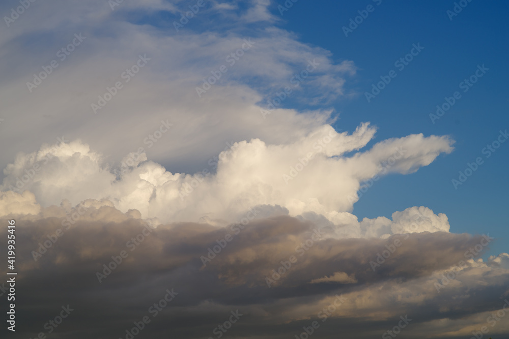 Cloudscape background taken in Southern California showing three layers of clouds with different colors and texture.