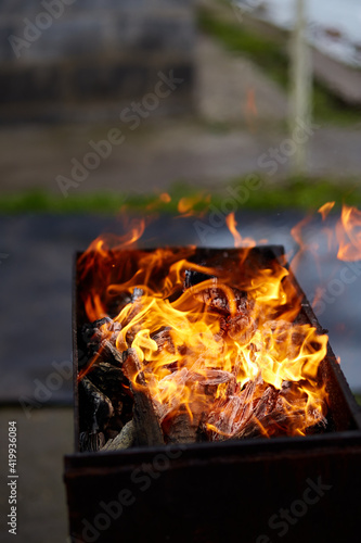 Flame from brazier. BBQ preparation close up