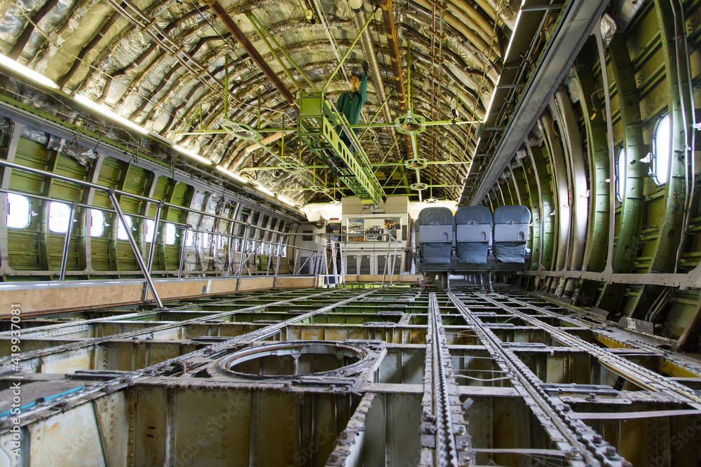 Inside view of stripped and raw airplane fuselage cabin with stringers, frames and floor structure - obrazy, fototapety, plakaty 