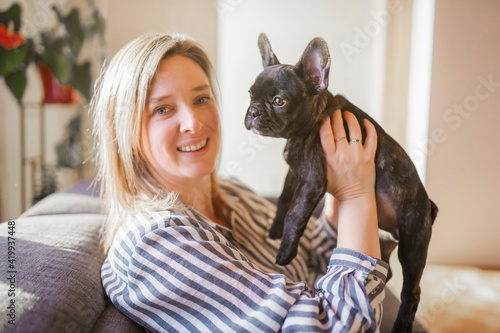 Obraz na plátně Portrait of happy adult at home with french bulldog