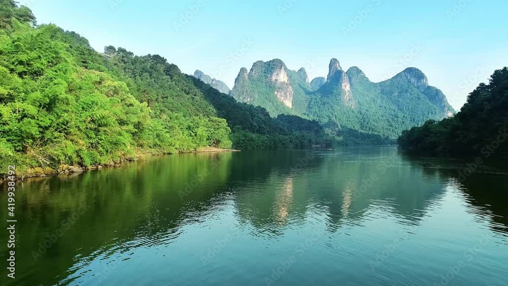 Under clear sky, aerial view of Li River and green trees and mountains on both sides in Guangxi. Pretty natural landscape Under clear sky, aerial view of Li River and green trees and mountains on both sides in Guangxi. Pretty natural landscape