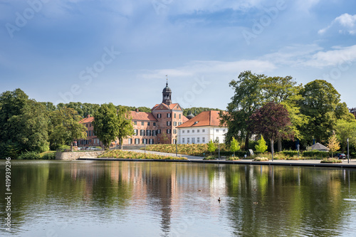 Lake and Castle of Eutin between Trees in Summer, Germany, Europe photo