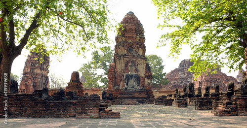 THAILAND AYUTTHAYA.  Wat Phra Mahatat, built in the 14th century, area dotted with small chedis and Khmer towers notably has a head of a Buddha statue where tree roots have grown around photo